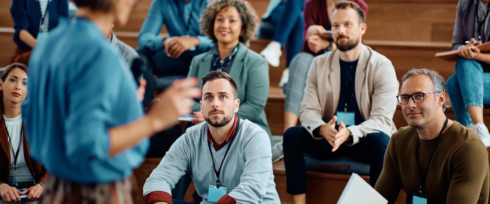 Business owners seated in a group listening to a speaker