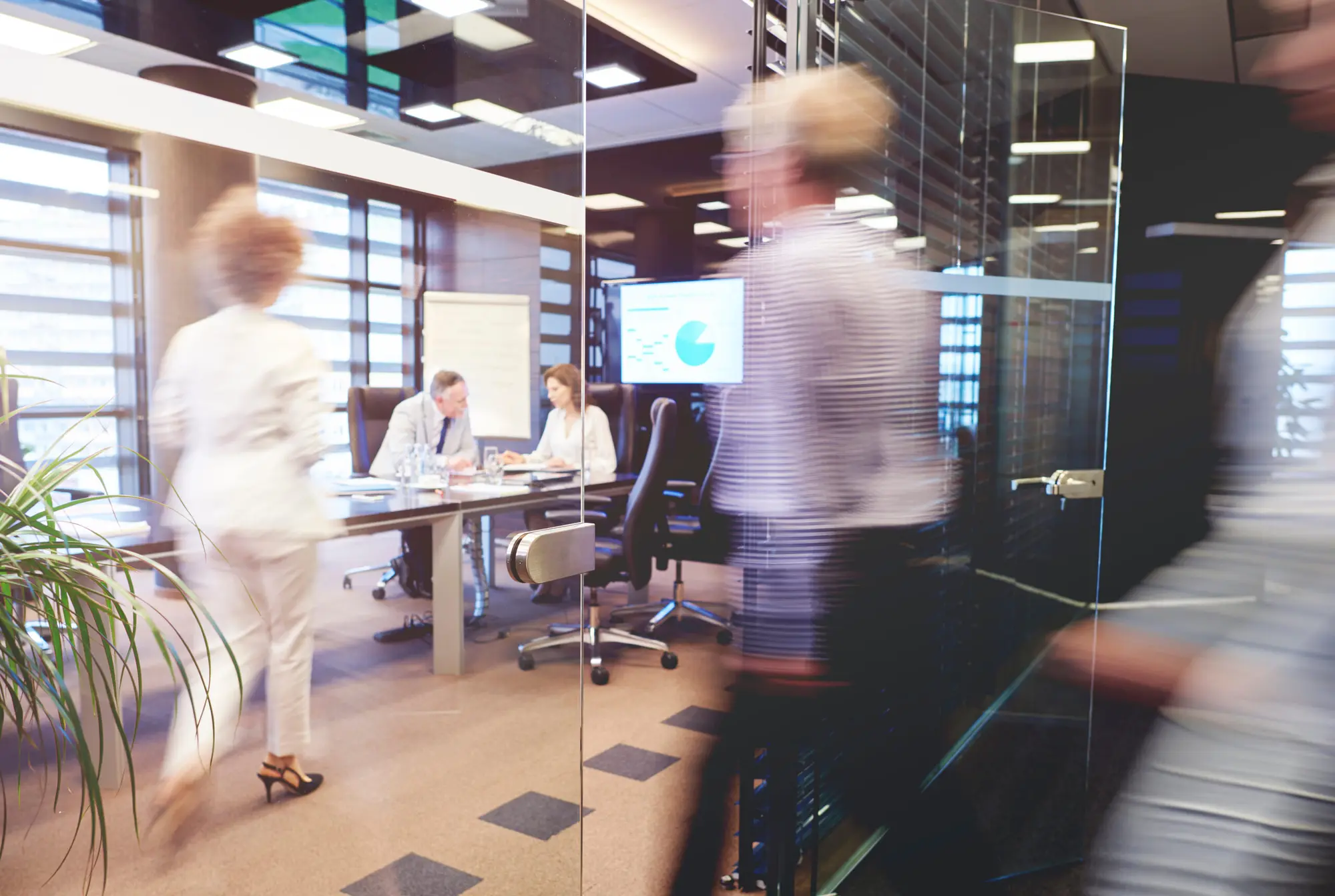 Team walking through a glass-walled office